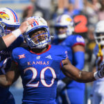 
              Kansas running back Daniel Hishaw Jr. (20) celebrates with teammate offensive lineman Mike Novitsky (50) after scoring a touchdown against Iowa State during the first half of an NCAA college football game, Saturday, Oct. 1, 2022, in Lawrence, Kan. (AP Reed/Hoffmann)
            