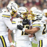 
              Missouri quarterback Brady Cook (12) celebrates a touchdown with tight end Ryan Hoerstkamp (84) and running back Cody Schrader (20) during the first half of an NCAA college football game against South Carolina, Saturday, Oct. 29, 2022,in Columbia, S.C. (AP Photo/Artie Walker Jr.)
            