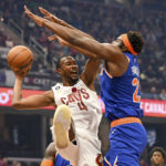
              Cleveland Cavaliers forward Evan Mobley (4) passes against New York Knicks center Mitchell Robinson (23) during the first half of an NBA basketball game, Sunday, Oct. 30, 2022, in Cleveland. (AP Photo/Nick Cammett)
            