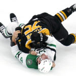 
              Boston Bruins defenseman Connor Clifton, top, drops Dallas Stars defenseman Colin Miller (6) to the ice during a fight in the first period of an NHL hockey game, Tuesday, Oct. 25, 2022, in Boston. (AP Photo/Charles Krupa)
            