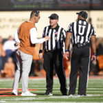 
              Texas head coach Steve Sarkisian, left, speaks with officials during the first half of an NCAA college football game against Oklahoma State, Saturday, Oct. 22, 2022, in Stillwater, Okla. (AP Photo/Brody Schmidt)
            