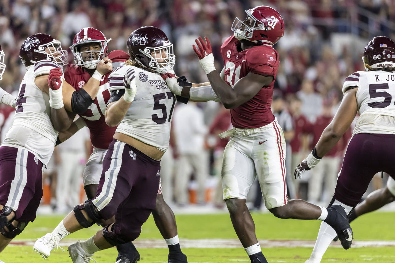 Mississippi State offensive lineman Cole Smith (57) works against Alabama linebacker Will Anderson ...