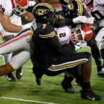
              Georgia running back Kendall Milton (2) is tackled by Missouri defensive lineman DJ Coleman (7) during the first half of an NCAA college football game Saturday, Oct. 1, 2022, in Columbia, Mo. (AP Photo/L.G. Patterson)
            