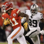 
              Kansas City Chiefs wide receiver Marquez Valdes-Scantling (11) runs with the ball past Las Vegas Raiders cornerback Nate Hobbs (39) during the first half of an NFL football game Monday, Oct. 10, 2022, in Kansas City, Mo. (AP Photo/Charlie Riedel)
            
