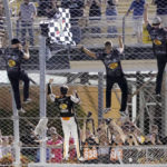 
              Noah Gragson, second from left, climbs the wall with his crew after winning the NASCAR Xfinity Series auto race at Homestead-Miami Speedway, Saturday, Oct. 22, 2022, in Homestead, Fla. (AP Photo/Terry Renna)
            