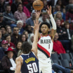 
              Portland Trail Blazers guard Anfernee Simons, right, shoots a 3-point basket over Denver Nuggets forward Aaron Gordon during the second half of an NBA basketball game in Portland, Ore., Monday, Oct. 24, 2022. (AP Photo/Craig Mitchelldyer)
            