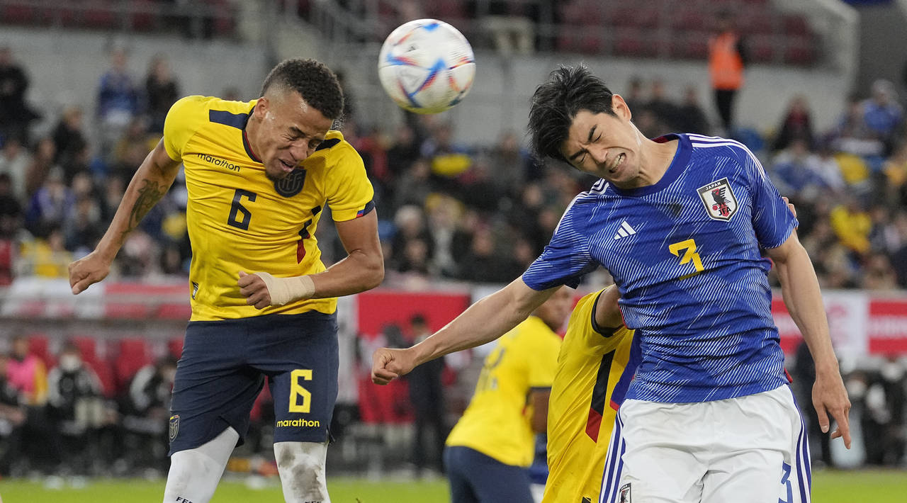 FILE - Ecuador's Byron Castillo, left, and Japan's Shogo Taniguchi challenge for the ball during th...