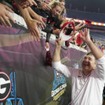 
              Georgia head coach Kirby Smart, right, high-fives fans after defeating Florida in an NCAA college football game, Saturday, Oct. 29, 2022, in Jacksonville, Fla. (AP Photo/John Raoux)
            