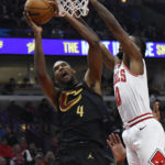 
              Cleveland Cavaliers' Evan Mobley (4) dunks against Chicago Bulls' Coby White (0) during the first half of an NBA basketball game Saturday, Oct. 22, 2022, in Chicago. (AP Photo/Paul Beaty)
            
