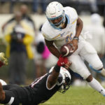 
              Jackson State linebacker Baron Hopson strips Southern University quarterback Besean McCray of the ball as he tries to run upfield during the first half of an NCAA college football game in Jackson, Miss., Saturday, Oct. 29, 2022. McCray recovered his fumble. (AP Photo/Rogelio V. Solis)
            