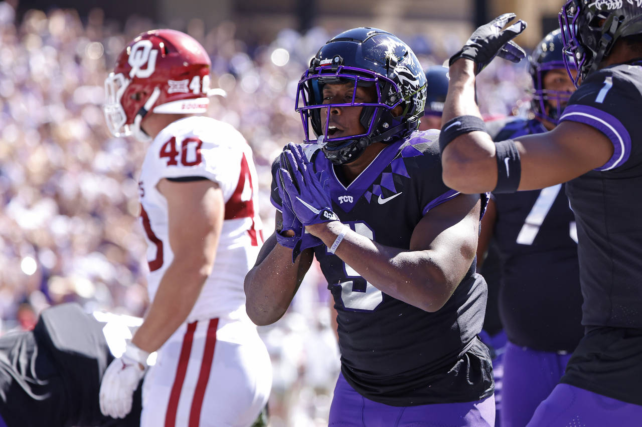 TCU running back Emari Demercado (3) celebrates with teammates after running for a touchdown agains...