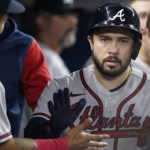 
              Atlanta Braves' Travis d'Arnaud is congratulated by teammates after he scored on a single by William Contreras during the fifth inning of a baseball game against the Miami Marlins, Tuesday, Oct. 4, 2022, in Miami. (AP Photo/Wilfredo Lee)
            