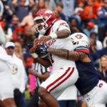 
              Arkansas quarterback KJ Jefferson scrambles for a touchdown as Auburn safety Donovan Kaufman, right, tries to tackle him during the first half of an NCAA college football game, Saturday, Oct. 29, 2022, in Auburn, Ala. (AP Photo/Butch Dill)
            