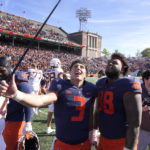 
              Illinois quarterback Tommy DeVito (3) and defensive lineman Keith Randolph Jr. celebrate the team's 26-14 win over Minnesota after an NCAA college football game Saturday, Oct. 15, 2022, in Champaign, Ill. Illinois won 26-14. (AP Photo/Charles Rex Arbogast)
            