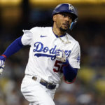 
              Los Angeles Dodgers' Mookie Betts rounds first base as he doubles during the third inning of a baseball game against the Colorado Rockies Saturday, Oct. 1, 2022, in Los Angeles. (AP Photo/Marcio Jose Sanchez)
            