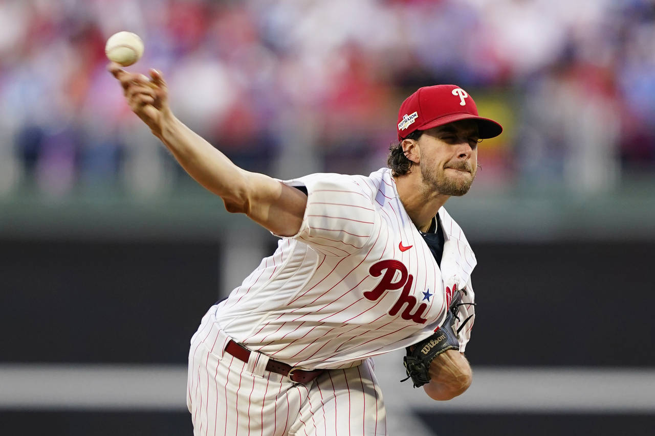 Philadelphia Phillies starting pitcher Aaron Nola (27) throws during the fourth inning in Game 3 of...