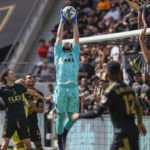 
              Los Angeles FC goalkeeper Maxime Crepeau, center, makes a catch against the Nashville SC during the first half of an MLS soccer match Sunday, Oct. 9, 2022, in Los Angeles. (AP Photo/Ringo H.W. Chiu)
            