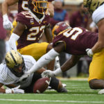 
              Minnesota defensive lineman Jalen Logan-Redding, second from right, recovers a fumble by Purdue running back Devin Mockobee during the first half an NCAA college football game on Saturday, Oct. 1, 2022, in Minneapolis. (AP Photo/Craig Lassig)
            