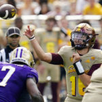 
              Arizona State's quarterback Trenton Bourguet, right, throws a touchdown pass as Washington's linebacker Dominique Hampton (7) applies pressure during the first half of an NCAA college football game in Tempe, Ariz., Saturday, Oct. 8, 2022. (AP Photo/Ross D. Franklin)
            