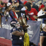 
              Fresno State defensive lineman Gavriel Lightfoot shows off the Old Oil Can trophy after a come-from-behind win against San Diego State during the second half of an NCAA college football game in Fresno, Calif., Saturday, Oct. 29, 2022. (AP Photo/Gary Kazanjian)
            
