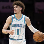 
              Charlotte Hornets guard LaMelo Ball brings the ball up court in the first half of an NBA preseason basketball game against the Washington Wizards in Charlotte, N.C., Monday, Oct. 10, 2022. (AP Photo/Jacob Kupferman)
            