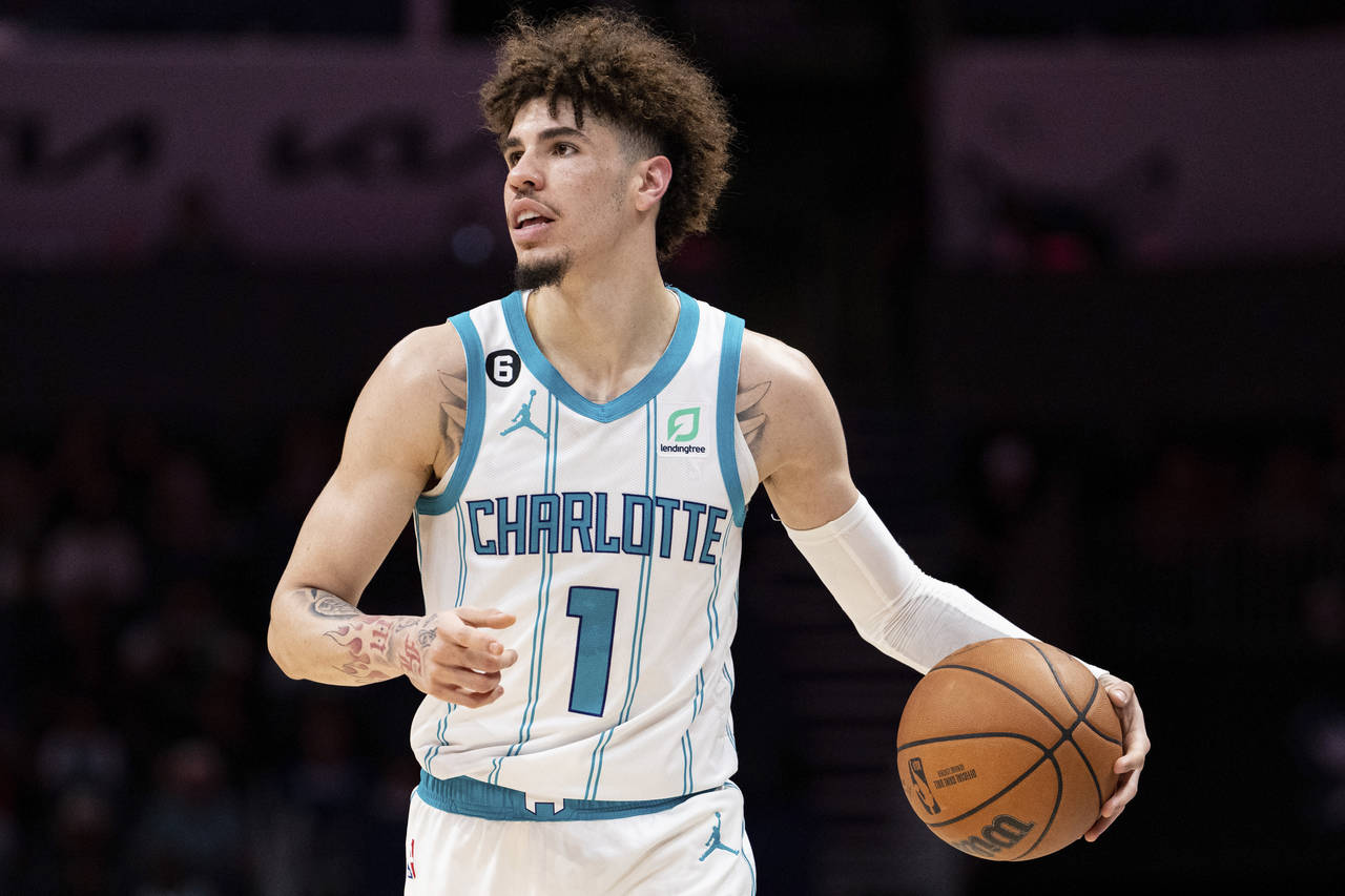 Charlotte Hornets guard LaMelo Ball brings the ball up court in the first half of an NBA preseason ...