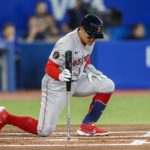 
              Boston Red Sox's Yu Chang (12) reacts after striking out in the second inning of a baseball game against the Toronto Blue Jays in Toronto, Sunday, Oct. 2, 2022. (Cole Burston/The Canadian Press via AP)
            