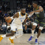 
              Los Angeles Lakers forward LeBron James (6) works toward the basket against Minnesota Timberwolves forward Jaden McDaniels (3) during the first half of an NBA basketball game, Friday, Oct. 28, 2022, in Minneapolis. (AP Photo/Abbie Parr)
            