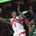 
              Toronto Raptors' O.G. Anunoby (3) shoots around Boston Celtics' Marcus Smart during second-half NBA preseason basketball game action in Montreal, Friday, Oct. 14, 2022. (Graham Hughes/The Canadian Press via AP)
            