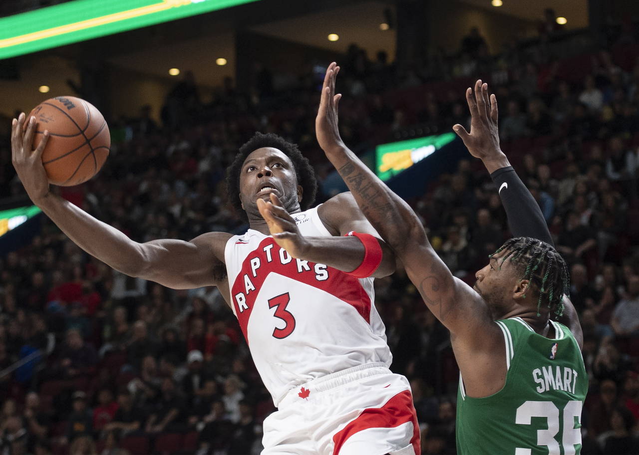 Toronto Raptors' O.G. Anunoby (3) shoots around Boston Celtics' Marcus Smart during second-half NBA...