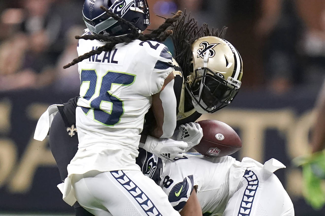 New Orleans Saints running back Alvin Kamara fumbles the ball after being hit by Seattle Seahawks c...