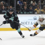 
              Seattle Kraken left wing Andre Burakovsky shoots the puck as Vegas Golden Knights center Chandler Stephenson defends during the second period of an NHL hockey game, Saturday, Oct. 15, 2022, in Seattle. (AP Photo/Jason Redmond)
            