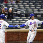 
              New York Mets' Brandon Nimmo (9) celebrates with teammate Francisco Lindor (12) after hitting a home run during the fourth inning in the first baseball game of a doubleheader against the Washington Nationals, Tuesday, Oct. 4, 2022, in New York. (AP Photo/Frank Franklin II)
            