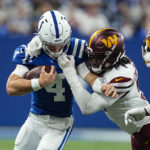 
              Indianapolis Colts quarterback Sam Ehlinger (4) is tackled by Washington Commanders defensive end James Smith-Williams (96) in the first half of an NFL football game in Indianapolis, Sunday, Oct. 30, 2022. (AP Photo/Darron Cummings)
            