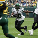 
              New York Jets running back Breece Hall (20) breaks up field during the first half of an NFL football game against the Green Bay Packers, Sunday, Oct. 16, 2022, in Green Bay, Wis. (AP Photo/Morry Gash)
            