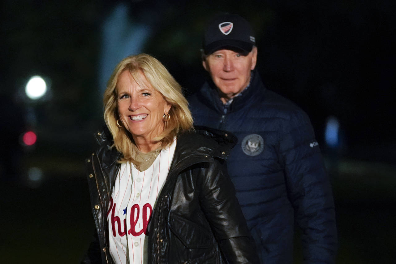 FILE - First lady Jill Biden wears a Philadelphia Phillies jersey as she and President Joe Biden wa...
