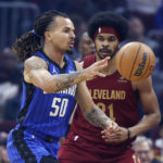 
              Orlando Magic guard Cole Anthony (50) passes against Cleveland Cavaliers center Jarrett Allen (31) during the first half of a NBA basketball game, Wednesday, Oct. 26, 2022, in Cleveland. (AP Photo/Ron Schwane)
            