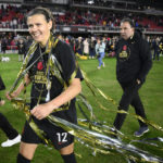 
              Portland Thorns FC forward Christine Sinclair (12) walks on the field with streamers after the NWSL championship soccer match against the Kansas City Current, Saturday, Oct. 29, 2022, in Washington. Portland won 2-0. (AP Photo/Nick Wass)
            