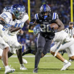 
              Duke's Jaquez Moore (20) carries the ball for a touchdown past North Carolina's Giovanni Biggers (27) during the first half of an NCAA college football game in Durham, N.C., Saturday, Oct. 15, 2022. (AP Photo/Ben McKeown)
            