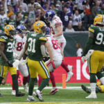 
              New York Giants tight end Daniel Bellinger (82), second left, celebrates with team-mates after scoring a touchdown during an NFL game between the New York Giants and the Green Bay Packers at the Tottenham Hotspur stadium in London, Sunday, Oct. 9, 2022. (AP Photo/Kin Cheung)
            