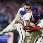 
              Philadelphia Phillies celebrate after winning the baseball NL Championship Series against the San Diego Padres on Sunday, Oct. 23, 2022, in Philadelphia. (AP Photo/Brynn Anderson)
            