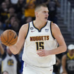 
              Denver Nuggets center Nikola Jokic brings the ball upcourt against the Golden State Warriors during the first half of an NBA basketball game in San Francisco, Friday, Oct. 21, 2022. (AP Photo/Jeff Chiu)
            
