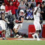 
              North Carolina State's Thayer Thomas (5) takes the ball into the end zone for a touchdown during the second half of an NCAA college football game against Virginia Tech in Raleigh, N.C., Thursday, Oct. 27, 2022. (AP Photo/Karl B DeBlaker)
            