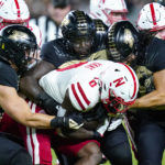 
              Nebraska running back Jaquez Yant (0) is tackled by Purdue linebacker Scotty Humpich, left, defensive end Sulaiman Kpaka, center and Purdue linebacker Kieren Douglas, right, during the first half of an NCAA college football game in West Lafayette, Ind., Saturday, Oct. 15, 2022. (AP Photo/Michael Conroy)
            