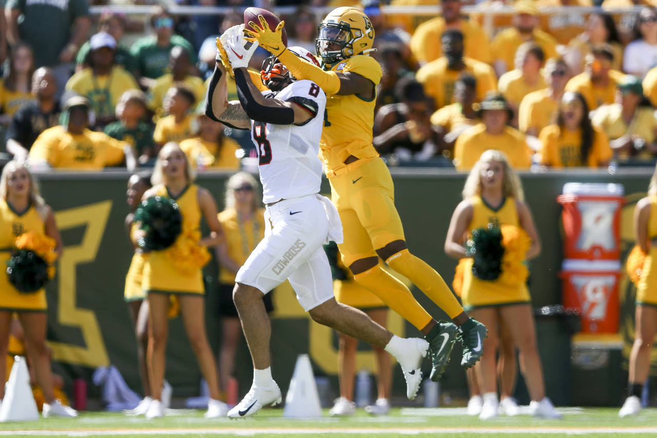 Baylor cornerback Lorando Johnson (11) breaks up a pass intended for Oklahoma State wide receiver B...