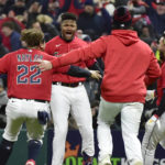 
              Cleveland Guardians' Oscar Gonzalez, second from left, is greeted by teammates after he drove in the winning run in the ninth inning of Game 3 of the baseball team's AL Division Series against the New York Yankees, Saturday, Oct. 15, 2022, in Cleveland. The Guardians won 6-5. (AP Photo/Phil Long)
            