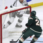 
              Los Angeles Kings' Gabriel Vilardi, top, skates behind the net after scoring a goal against the Minnesota Wild during the first period of an NHL hockey game, Saturday, Oct. 15, 2022, in St. Paul, Minn. At right is Wild's Matt Dumba. (AP Photo/Jim Mone)
            
