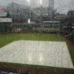 
              Rain hits a window overlooking Truist Park before Game 2 of baseball's National League Division Series between the Atlanta Braves and the Philadelphia Phillies, Wednesday, Oct. 12, 2022, in Atlanta. The game has been rain delayed. (AP Photo/John Bazemore)
            