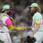 
              San Diego Padres catcher Austin Nola, left, celebrates with relief pitcher Josh Hader after the Padres defeated the Chicago White Sox 5-2 in a baseball game Saturday, Oct. 1, 2022, in San Diego. (AP Photo/Gregory Bull)
            