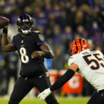 
              Baltimore Ravens quarterback Lamar Jackson passes the ball over Cincinnati Bengals' Logan Wilson during the second half of an NFL football game, Sunday, Oct. 9, 2022, in Baltimore. (AP Photo/Julio Cortez)
            